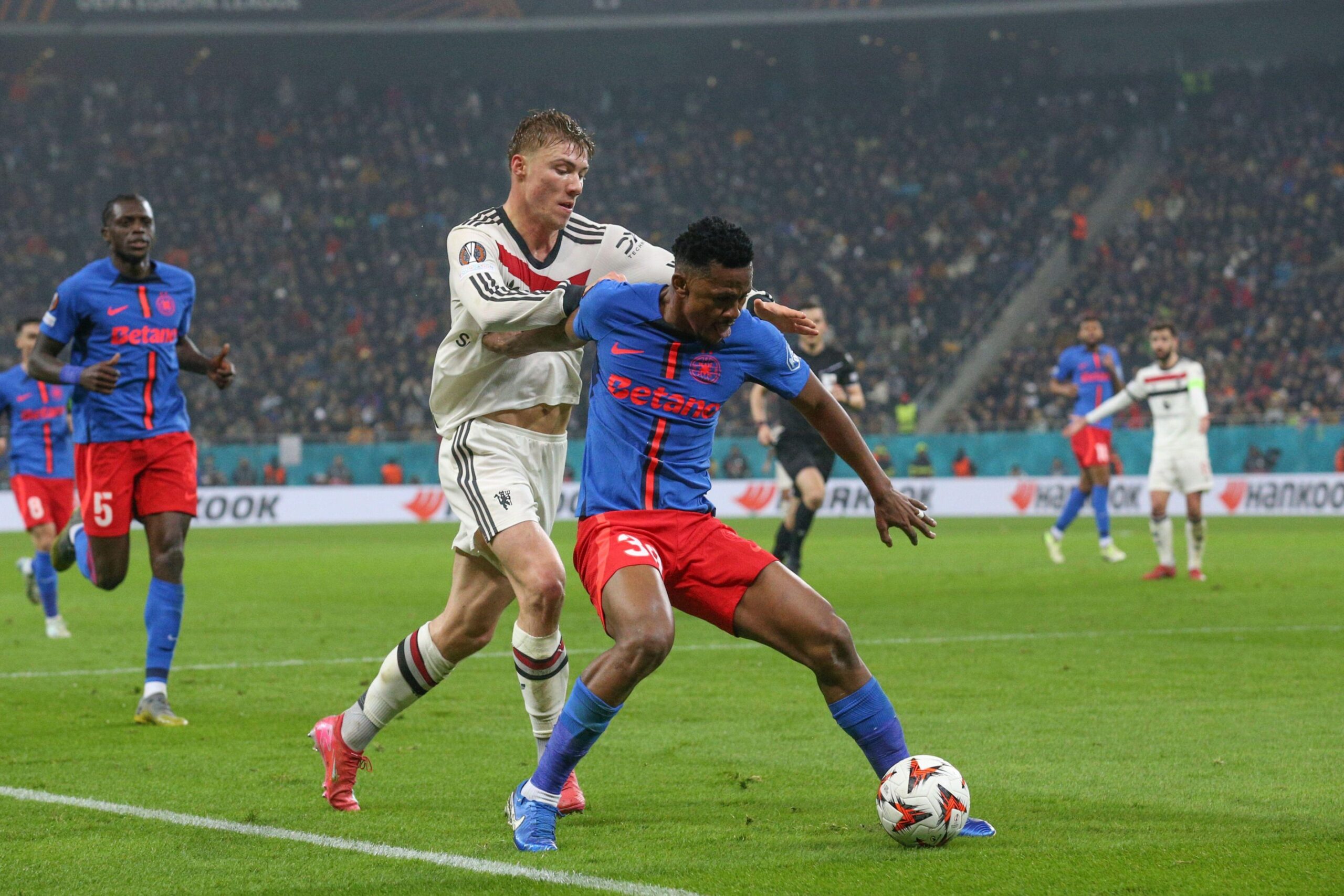 Manchester United forward Rasmus Hojlund Højlund battles with Siyabonga Ngezana during the FCSB v Manchester United FC UEFA Europa League match