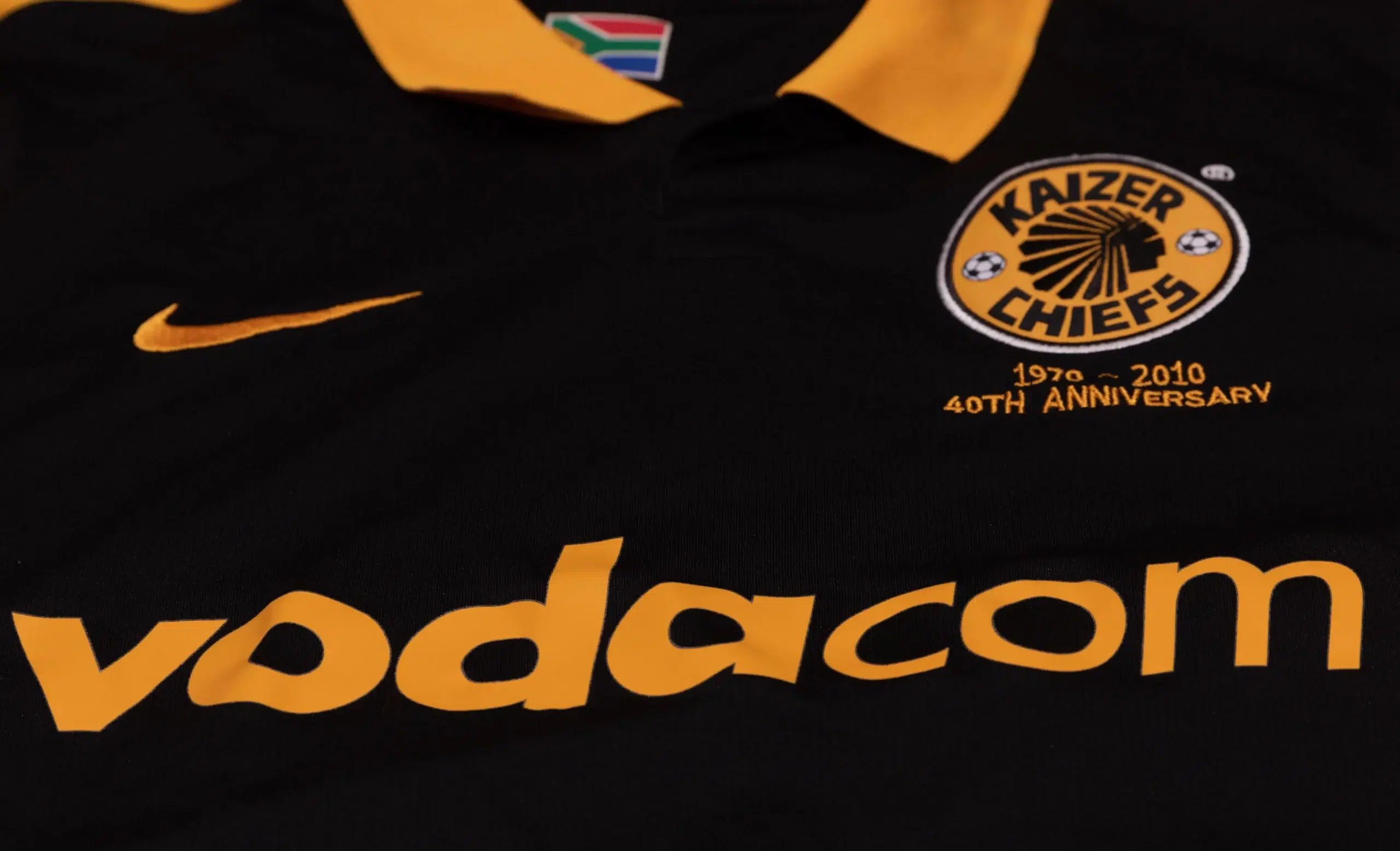 Sponsors on the front of a Kaizer Chiefs 40th Anniversary football shirt