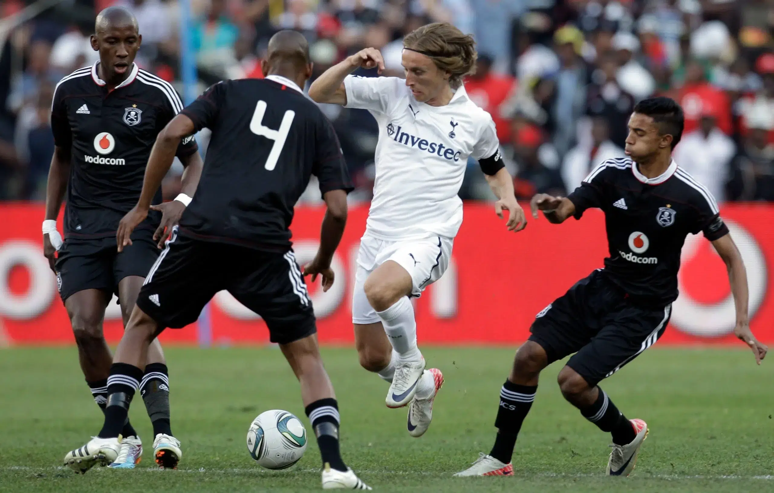 Tottenham Hotspur Luka Modric, second from right, attacks as Orlando Pirates players defend