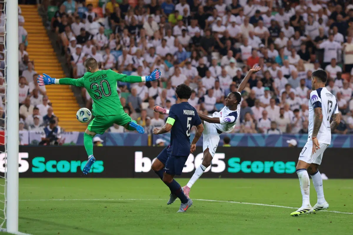 Lucas Chevalier of PSG denies Pape Matar Sarr of Tottenham Hotspur FC a chance to score, UEFA Super Cup match 2025