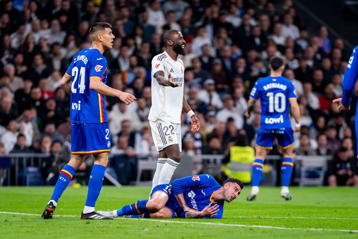 Diego Rico of Getafe CF (R) is seen on the ground after receiving a foul from Antonio Rudiger of Real Madrid, 2026