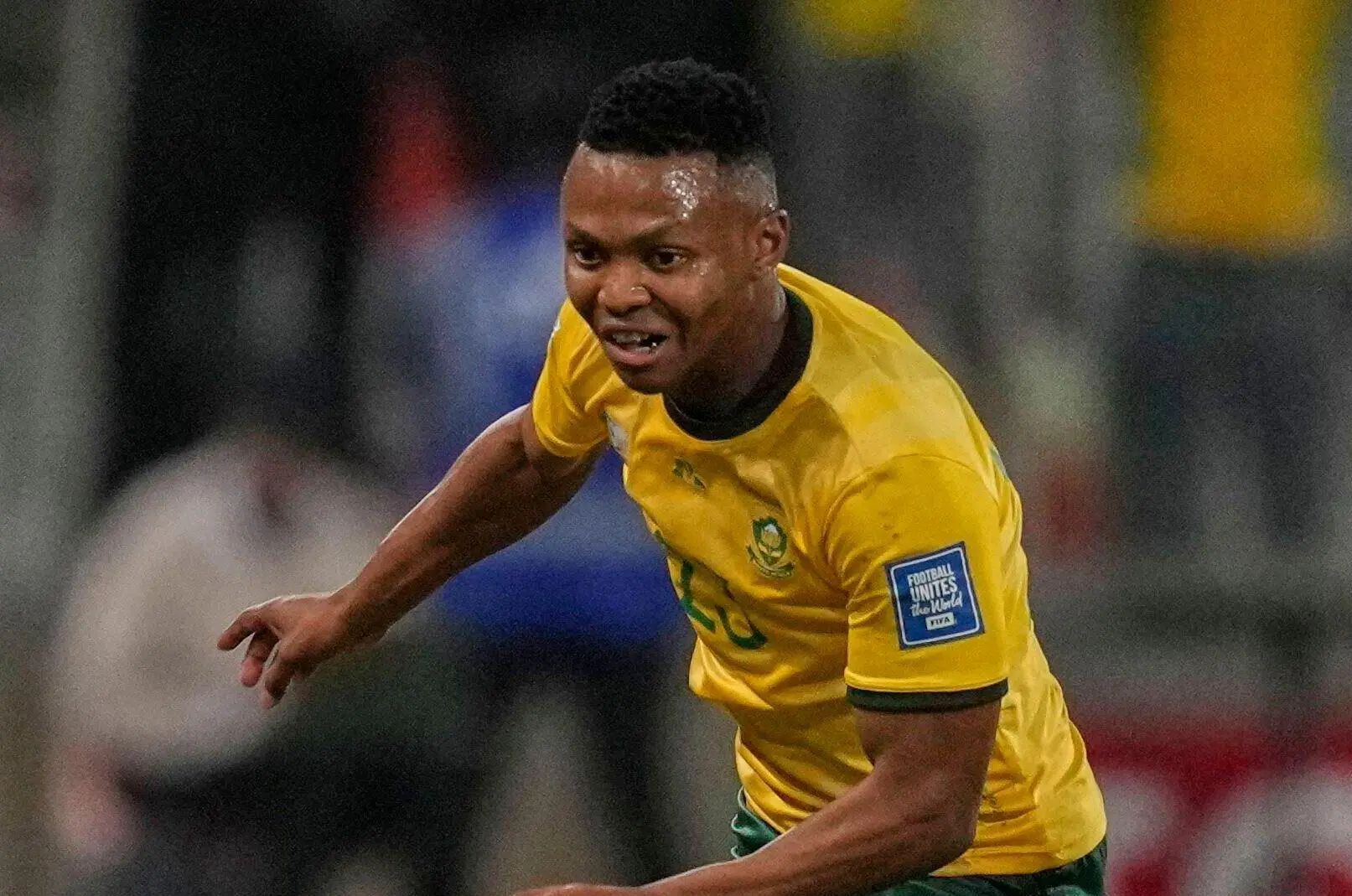 South Africa's Mohau Nkota chases the ball during a World Cup Group C qualifying soccer match between South Africa and Nigeria