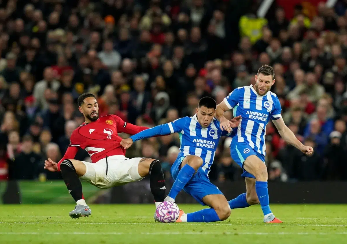 Matheus Cunha of Manchester United tackled by Diego Gómez of Brighton and James Milner of Brighton during the Manchester United vs Brighton and Hove Albion Premier League match, 25th Oct, 2025